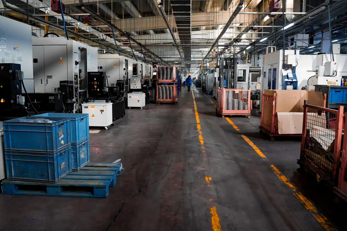 Hală de producție cu utilaje, lăzi și posturi de lucru
